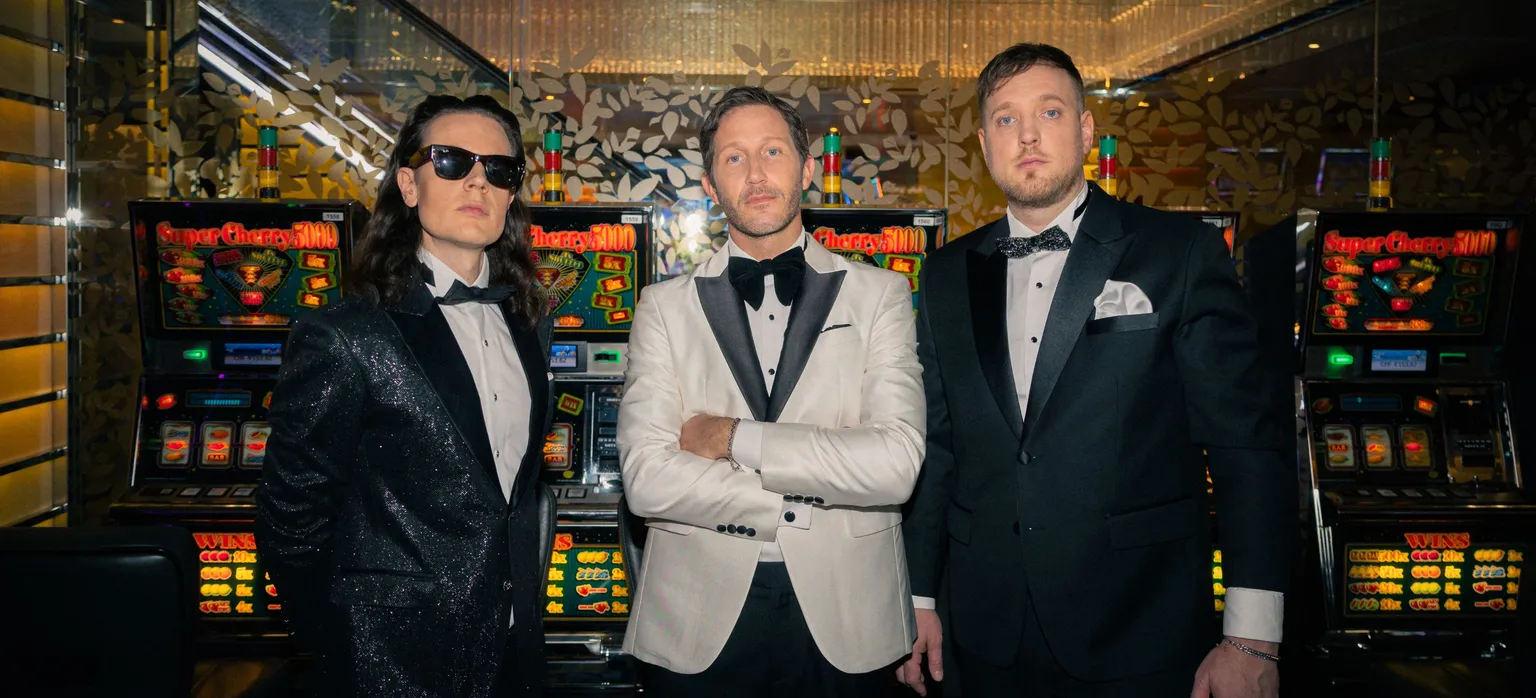 Baba Shrimps Band posing in front of a dark bar counter